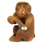 An Oriental carved wooden monkey figure with glass eyes (possibly Japanese), H. 30cm.