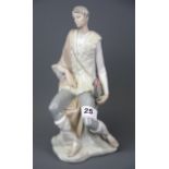 A Lladro shepherd figurine carrying flowers, H. 26cm.