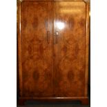 An Art Deco walnut veneered double wardrobe, W. 117cm H. 185cm.