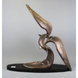 An original bronzed spelter sculpture of a seagull flying over waves on a marble plinth, H. 57cm, L.