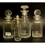 A group of three cut glass decanters and a small silverplate mounted jug.