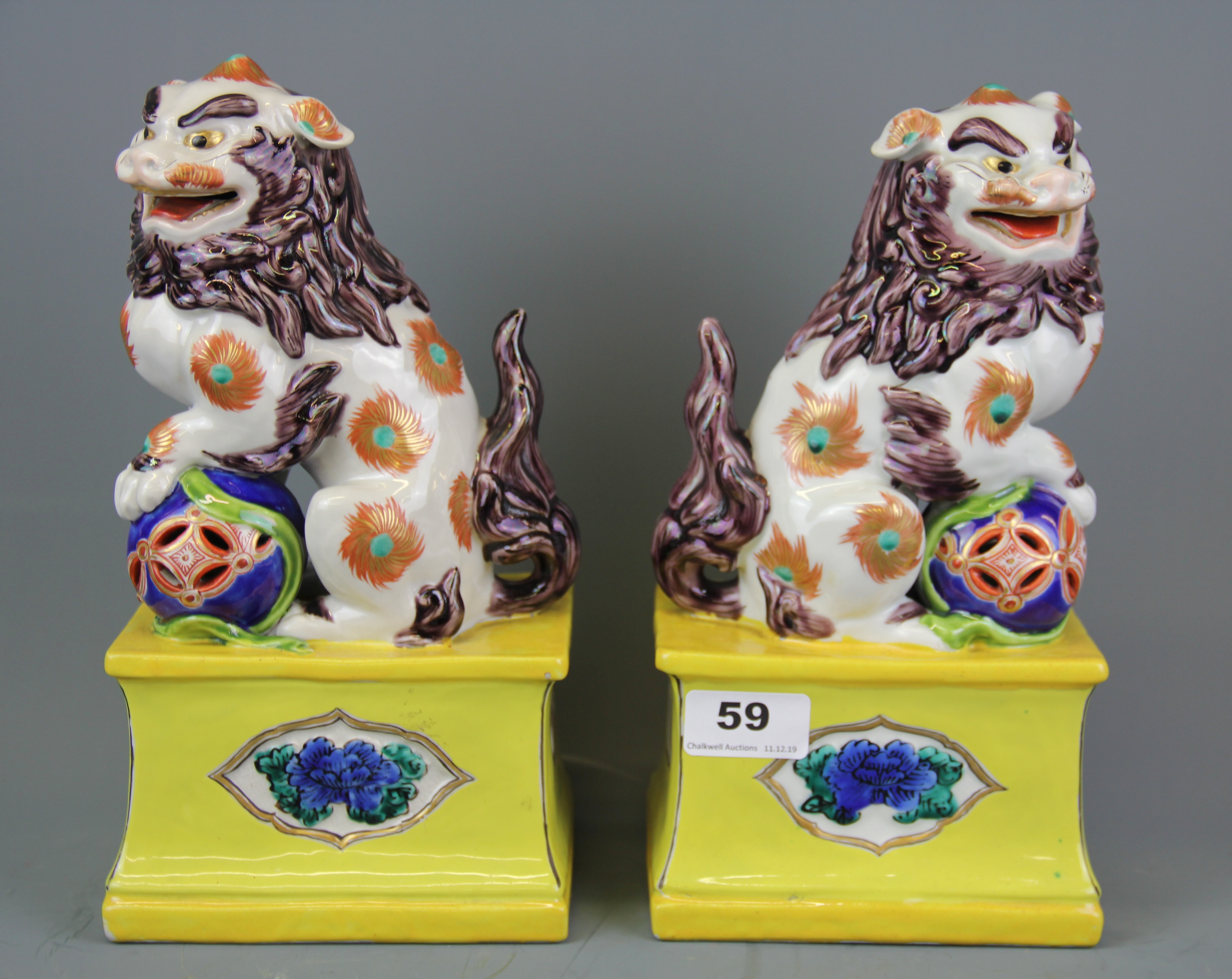 A pair of Japanese Kutani temple lions, H. 26cm.