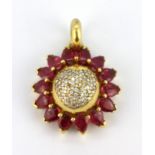 A yellow metal (tested 18ct gold) pendant set with pear cabochon cut rubies and diamonds, L. 3cm.