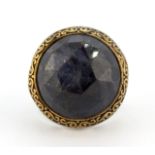 An Oriental 925 silver and bronze ring set with a large faceted cut sapphire, (X).