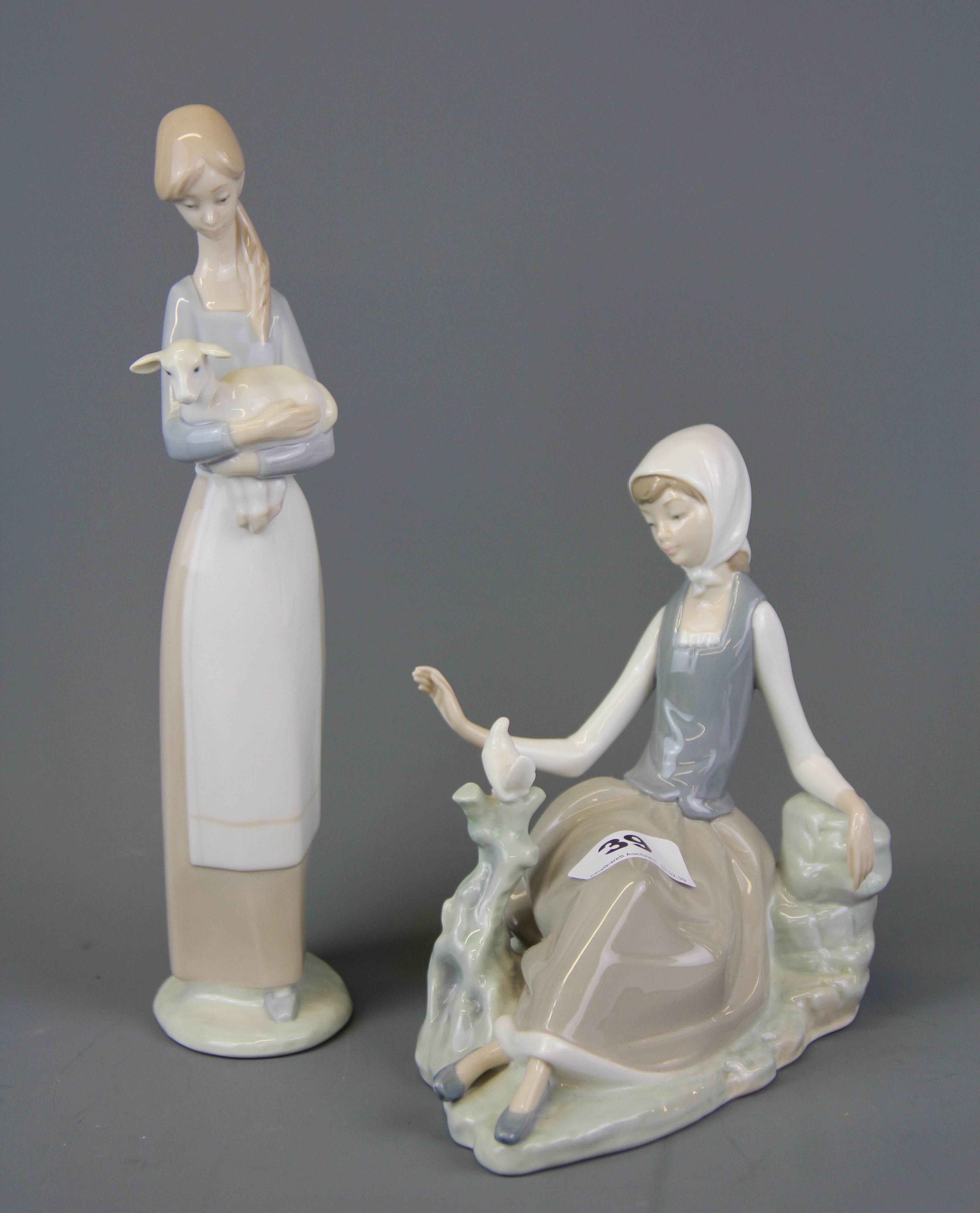 Two Lladro figures of young ladies with animals, tallest 28cm.
