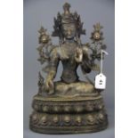 A Tibetan bronze figure of the seated Tara, H. 35cm.