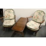 A pair of Ercol style upholstered armchairs together with similar coffee table.