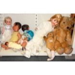 Two early teddy bears and a group of celluloid dolls.