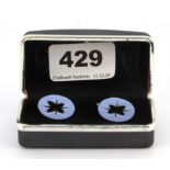 A boxed pair of 925 silver carved hardstone set cufflinks.