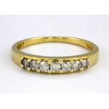 An 18ct yellow gold (stamped 18k) diamond set half eternity ring, (N.5).