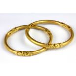 A pair of yellow metal (tested minimum 18ct gold) bangles, Dia. 7cm.
