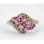 A 9ct white gold ring set with pink sapphires and diamonds, (M).