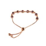 A 925 silver rose gold gilt tanzanite set adjustable bracelet.