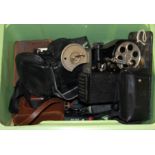A vintage hand crafted 8mm projector and a group of cameras.