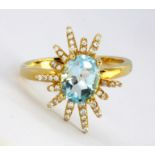 A 925 silver gilt ring set with oval cut Swiss blue topaz and white stones, (R).