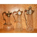Three silver plate mounted claret jugs, tallest H. 31.5cm.