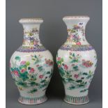 Two Chinese hand painted porcelain vases of the same pattern but different shaped bodies, H. 41cm.