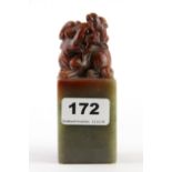 A mid 20th Century Chinese carved mix coloured soapstone scholars seal, H. 12cm.