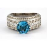 A 925 silver ring set with blue topaz and white stones, (N).