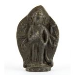 A Tibetan cast bronze home shrine figure of a multi-armed deity, probably collected on a pilgrimage.