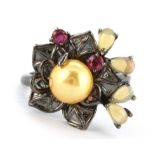 A 925 silver flower shaped ring set with opals, rubies and a cream pearl, (P.5).