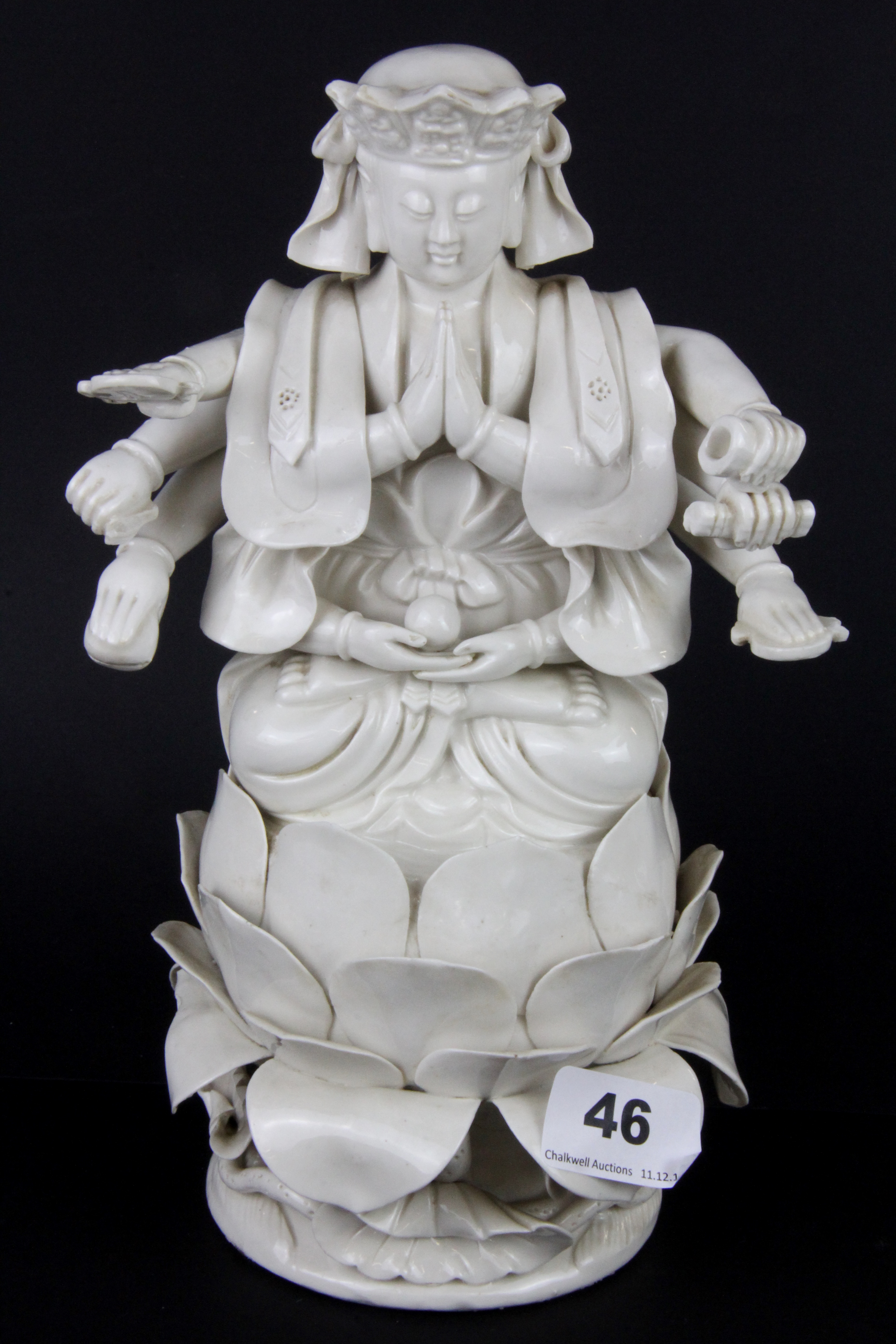 An early 20thC Tibetan blanc de chine glazed ceramic figure of a multi armed deity, H. 26cm.