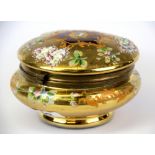 A gilt hand painted glass hinged box and cover with applied decoration, H. 11cm, Dia. 16cm.