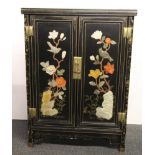 A Chinese lacquered cabinet decorated with inlaid carved semi-precious stones, size 77 x 56 x 28cm.