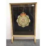 An embroidered Army Service Corps badge made by David Wilkinson in 1918 mounted into a fire screen