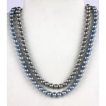 A bluish grey pearl necklace on a silver clasp and a further grey pearl necklace, L. 46 & 40cm.