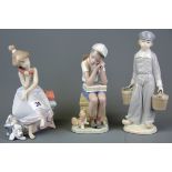 Three Lladro figurines of children, tallest 22.5cm.