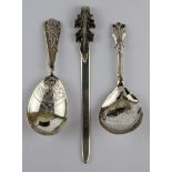 Two silver caddy spoons and a silver book mark.
