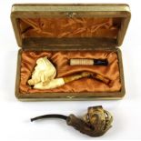 A boxed Meerschaum pipe together with a further Victorian pipe.