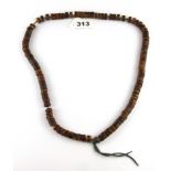 A strand of Tibetan carved human skull prayer beads, folded L. 37.5cm.