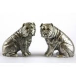 A pair of silver plated bulldog salt and peppers with glass eyes, H. 6cm.