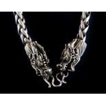 A heavy Chinese white metal chain with dragons head clasp, L. 61.5cm.