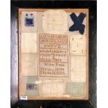 A Victorian framed sampler c.1879, surrounded by other early fabric items, framed size 60 x 49cm.