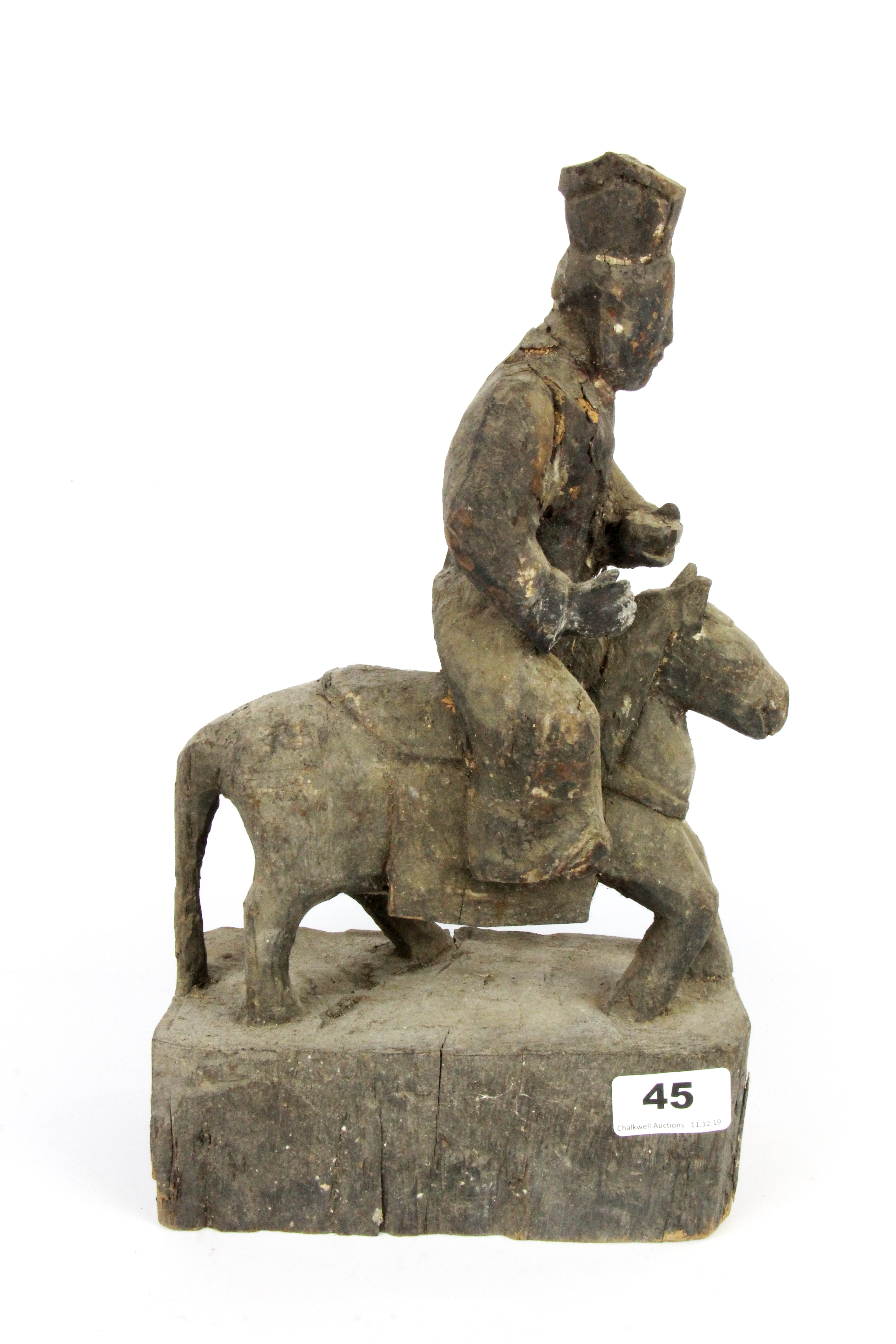 A rare Chinese Qing dynasty carved wooden figure of a deity riding a horse with a prayer cavity in