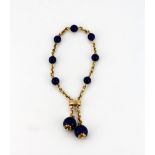 A Victorian yellow metal (tested 15ct gold) adjustable bracelet set with polished lapis lazuli