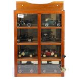 A wall mounted wooden display cabinet containing die cast model vehicles, case size 47 x 34 x 11cm.