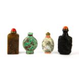 A group of four Chinese snuff bottles, including two porcelain, one carved stone with seal base