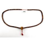 A strand of Tibetan carved bone prayer beads, folded L. 52cm.