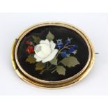 A yellow metal (tested 9ct gold) pietradura brooch, 4 x 3.5cm.