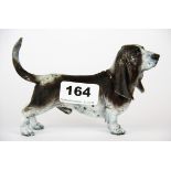 A cold painted bronze figure of a basset hound dog H. 9cm L. 15cm.