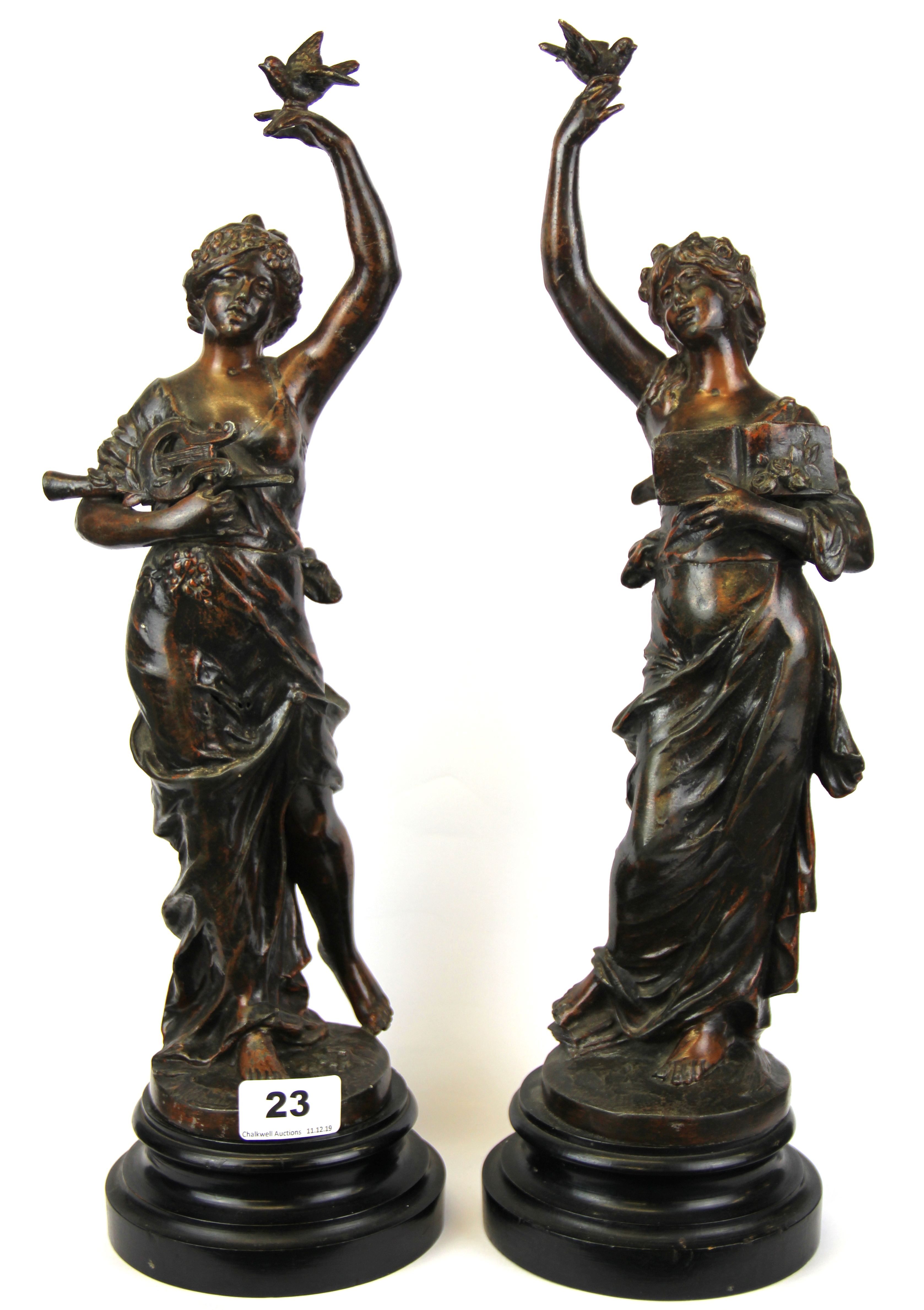 A pair of bronzed spelter muse figures on wooden plinths, H. 44cm.