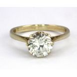 An 18ct yellow gold stone set solitaire ring, (M).