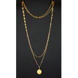 A 9ct yellow gold Libra pendant on a 15ct yellow gold (stamped 15) long chain, L. 1600cm.