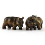 Two carved fruitwood netsuke of hippos, longest 6cm.