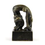 An unusual Chinese cast bronze seal mounted with a cartoon like cat, H. 5.5cm.