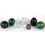 Seven glass paperweights including a Caithness and Dartington paperweight.